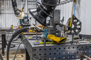A table in Yoder Industries with a bunch of pieces of welding equipment.