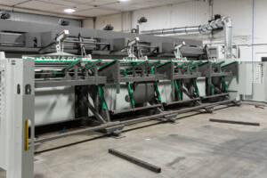 Large laser tube cutting machine shown in Yoder Industries metal cutting shop.
